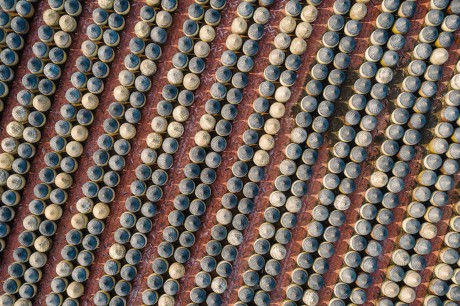 Traditional soy sauce factory, aerial view of the fermented field with numbers of earthen jars on the ground, where soya beans are fermented to produce the soy sauce.
